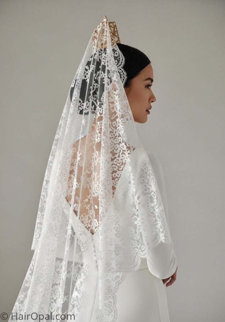 Bride with minimalist low bun long cathedral mantilla veil hairstyle bun vintage