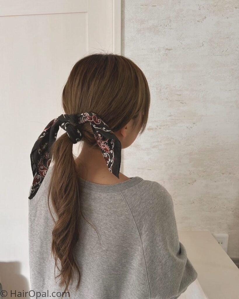 High ponytail styled with a bandana for an easy summer camp look