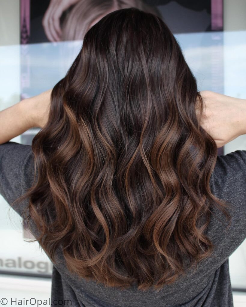 Woman with dark chocolate hair and caramel balayage fall color